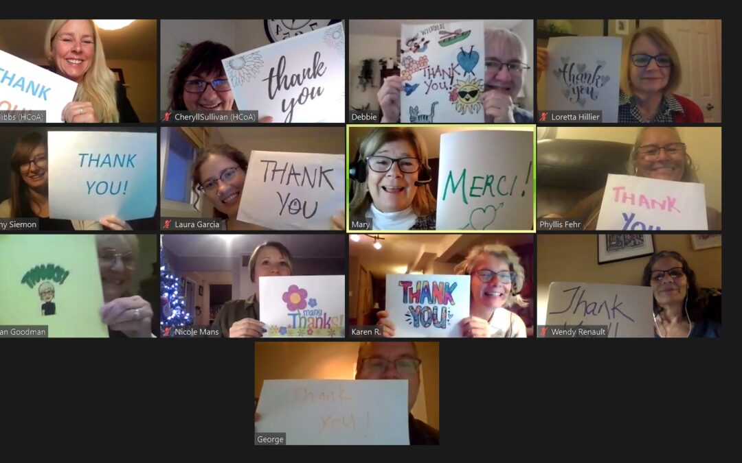 A screenshot of the DFC working group all holding up handmade signs that say "thank you"