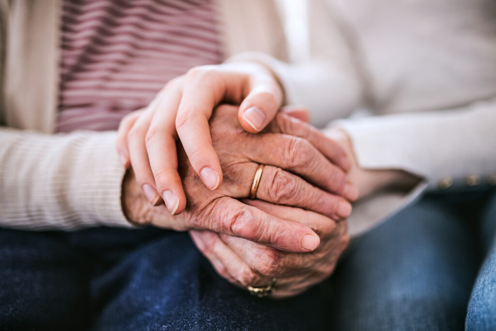 A close up of two people's hands intertwined