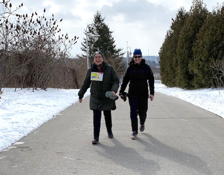 Picture of two people walking along a path in the winter