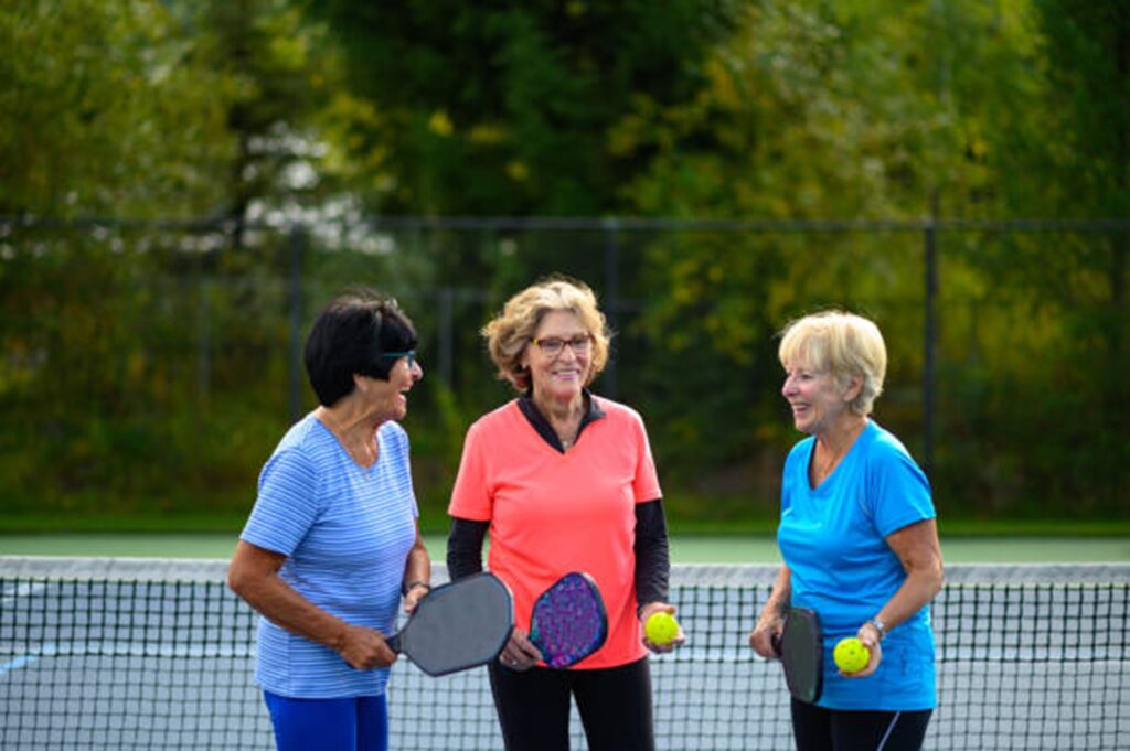 Photo of older adults playing tennis